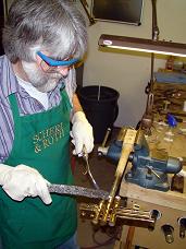 David Askren soldering a trumpet